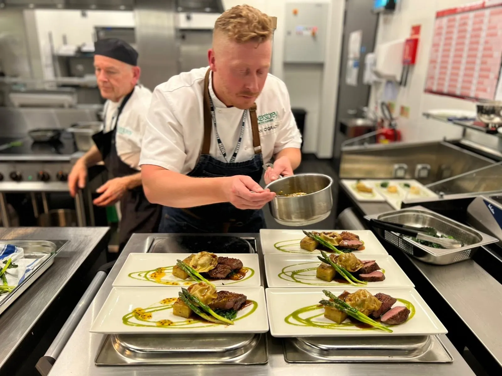 Chef finishing a plated main course for conference catering Dublin