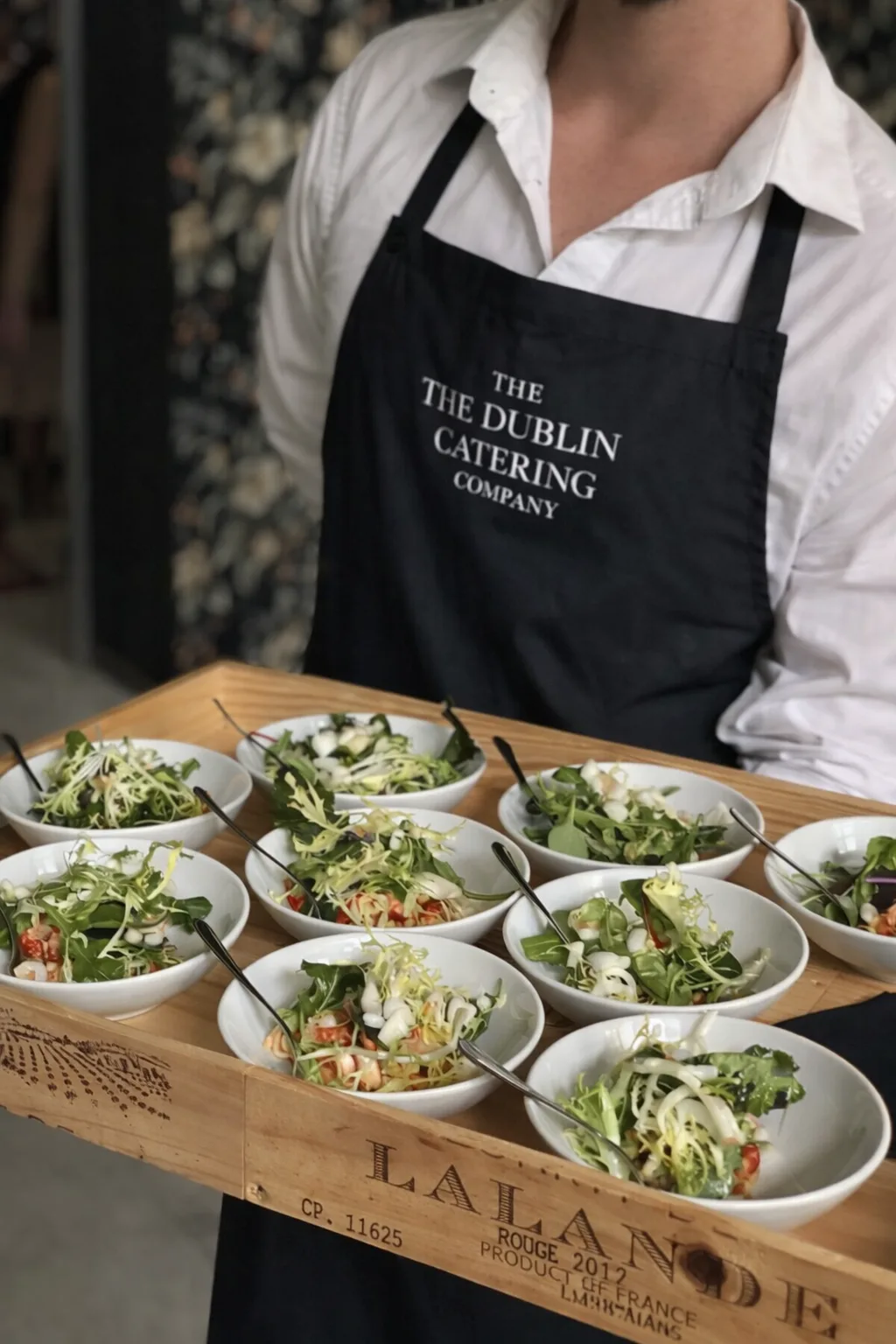 The Dublin Catering Company team carrying fresh salad bowls at a private event Dublin